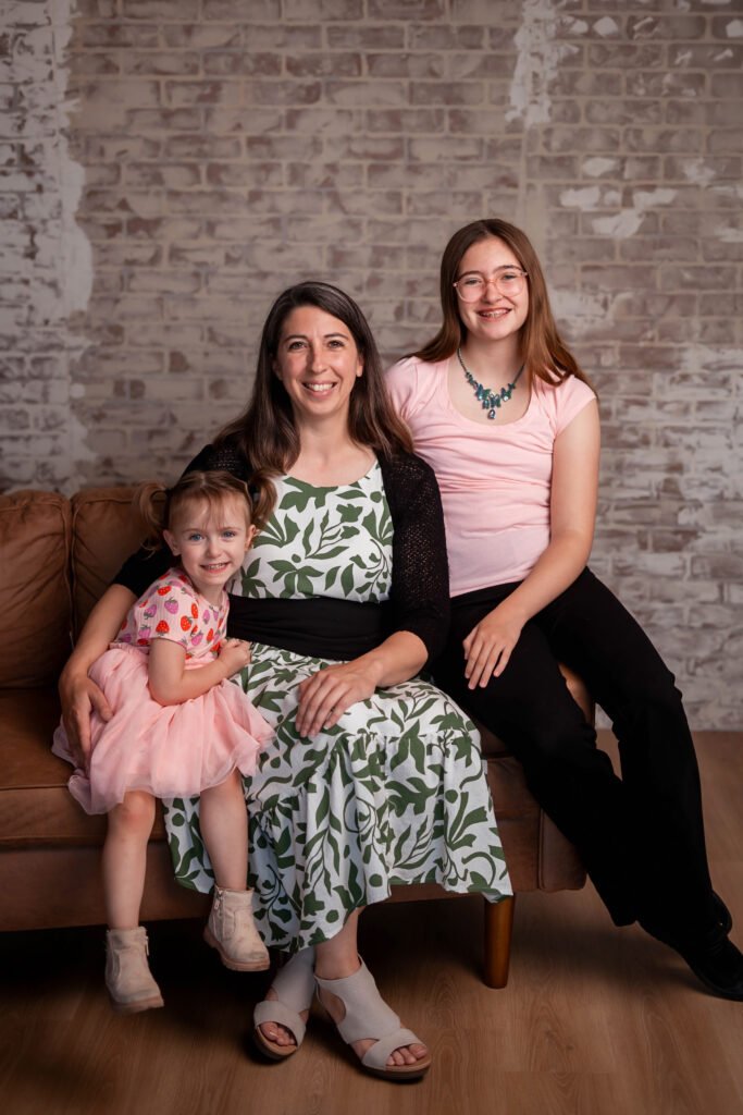 Family picture of two girls and their mother. 